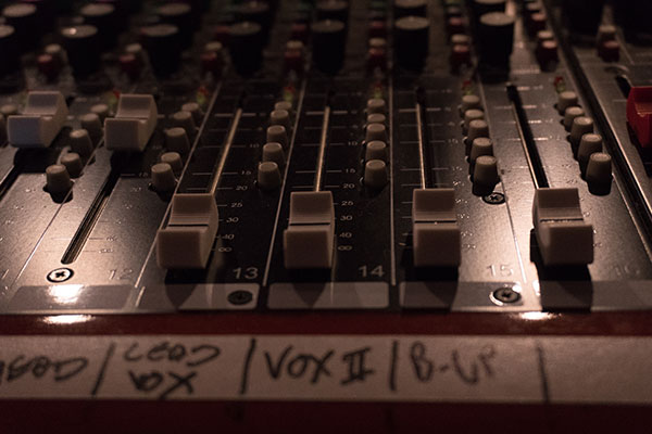 Mixing board with white faders